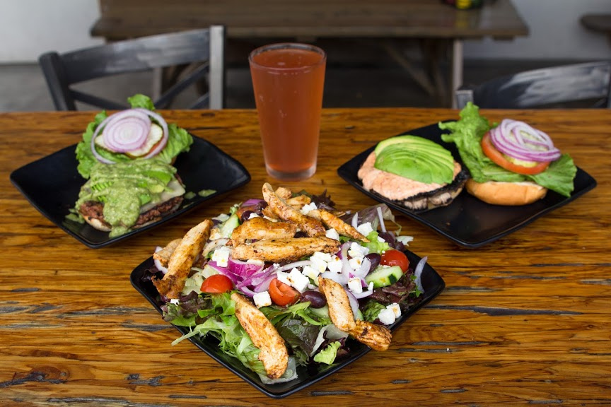 Grilled meat with salad on the side, burger and grilled meat with green salad